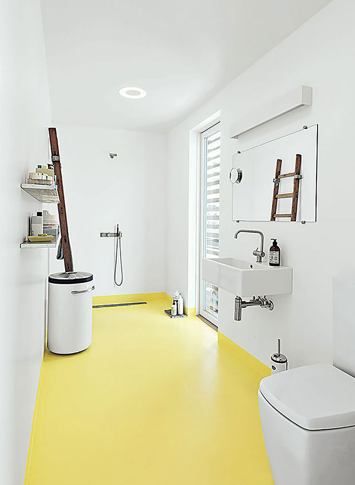 Baño minimalista con ducha abierta y suelo amarillo
