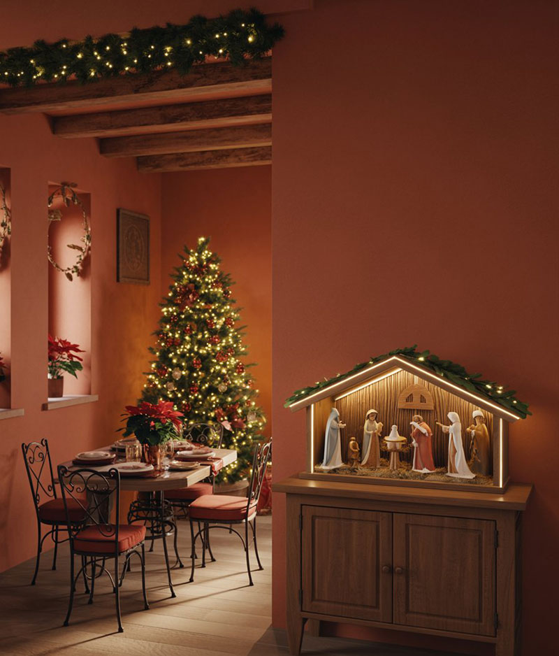 Un comedor con decoración navideña, un árbol de Navidad y un belén pesebre compleeto