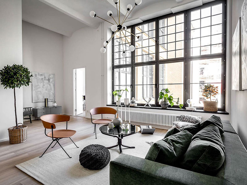 Salón moderno de estilo escandinavo con grandes ventanales y alfombra blanca